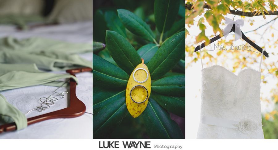 Wedding details: green shirt on hanger, rings on yellow leaf, white dress on hanger outdoors.
