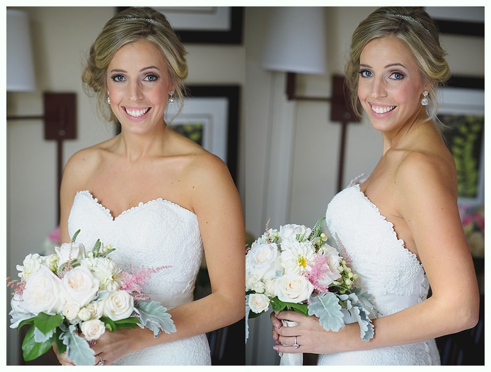 Bride in strapless lace dress, holding a bouquet, smiling. Interior setting.