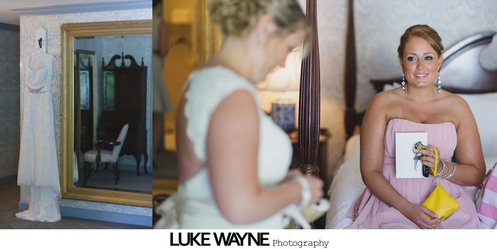 Wedding day preparation: bride in veil, another in a dress looking at her, and a bridesmaid in pink holding a card and purse.