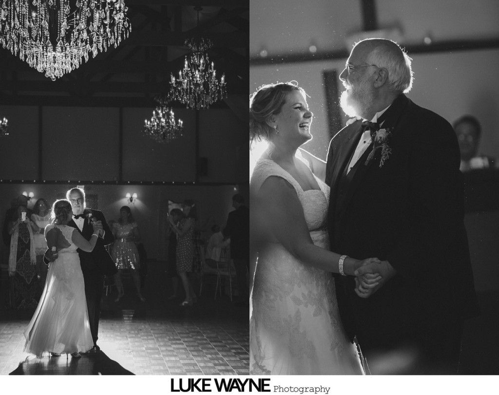 Bride and father dance at wedding reception, smiles and chandeliers overhead.