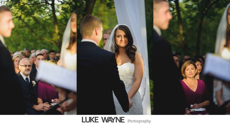 Wedding ceremony: Bride and groom exchanging vows outdoors, guests watch.