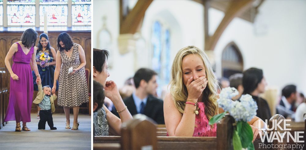 Couple embraces on a rocky outcrop, facing each other. Black and white photograph, cloudy sky, tree on the left.
