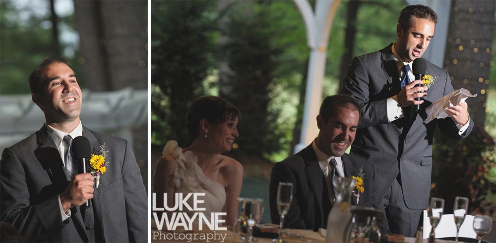 Couple embracing at sunset; man in green shirt, woman in denim jacket and red dress, with blowing hair.