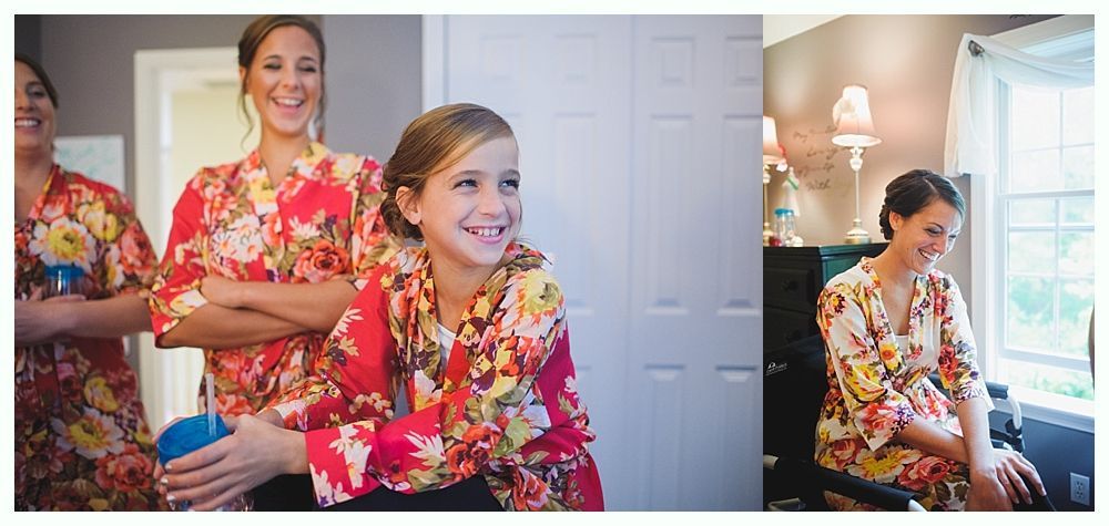 Women and a girl in floral robes smile, some with arms crossed, in a room.