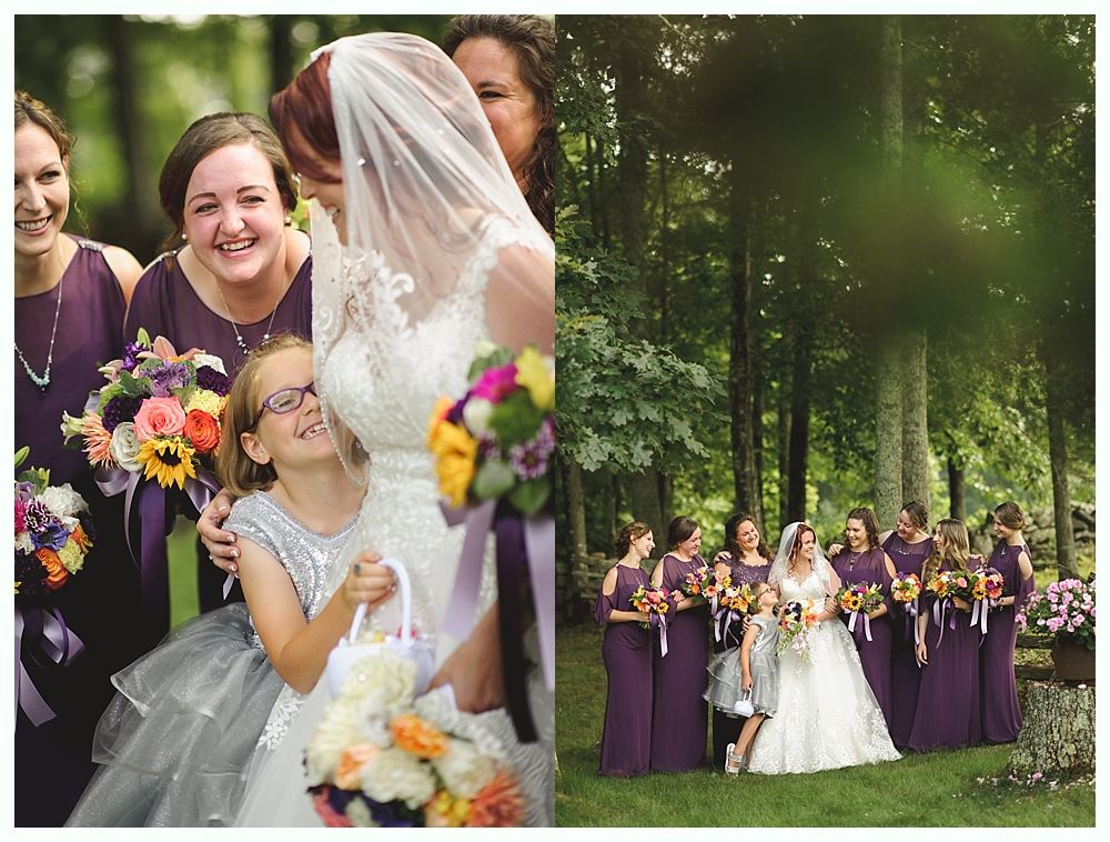 Couple embracing in a field with tall grass, trees in the background shrouded in fog.
