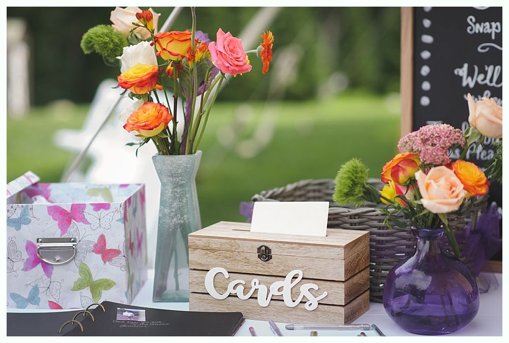 Woman with braided hair smiling, touching her hair, looking down at a man leaning in close, black and white photo.