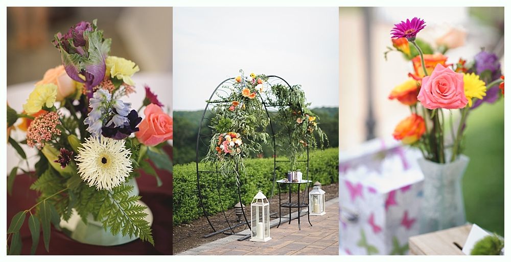 Couple embraces. Woman in white dress, man with beard. Outdoor setting with greenery and wooden door.