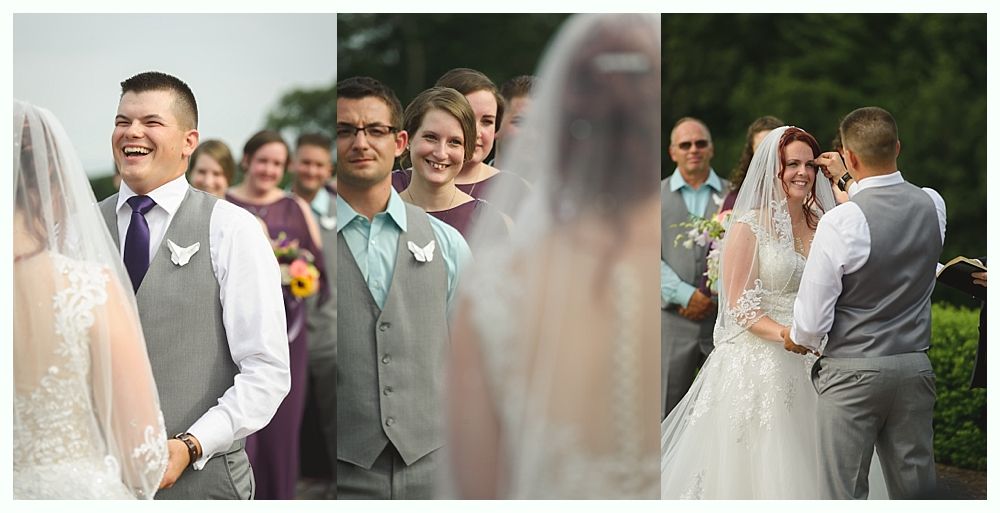 Diamond engagement ring on yellow flower in tall grass.