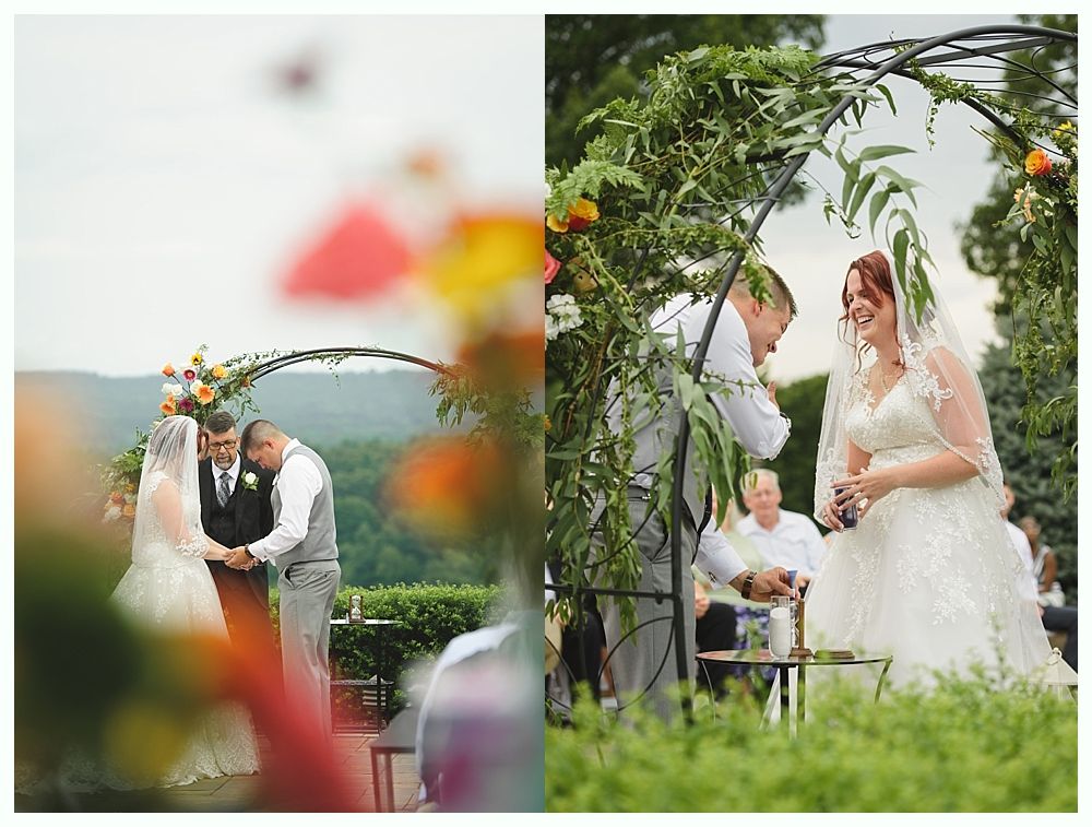 Diamond engagement ring on yellow flower in tall grass.