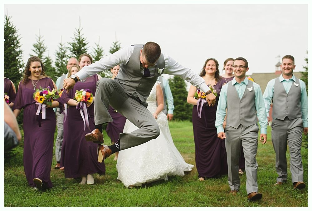 Diamond engagement ring on yellow flower in tall grass.