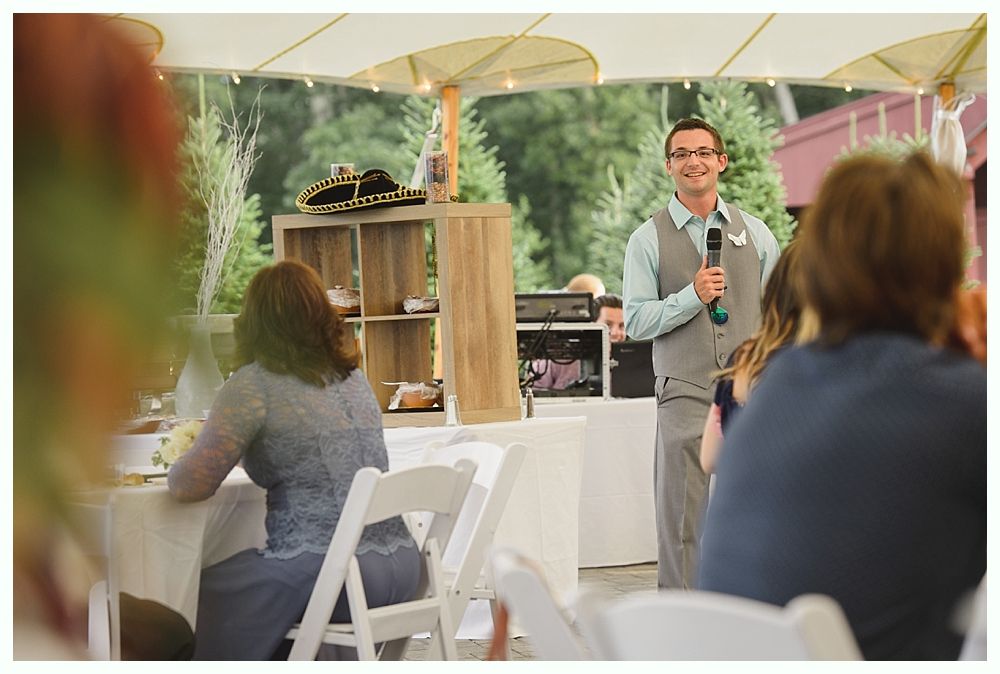 Diamond engagement ring on yellow flower in tall grass.