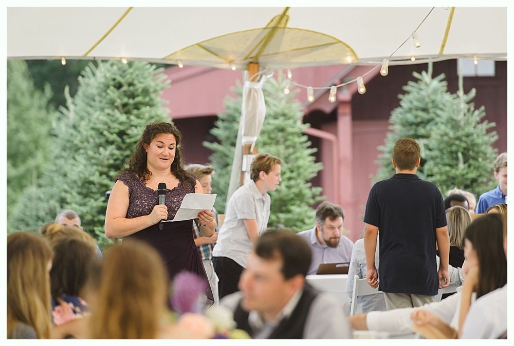 Diamond engagement ring on yellow flower in tall grass.