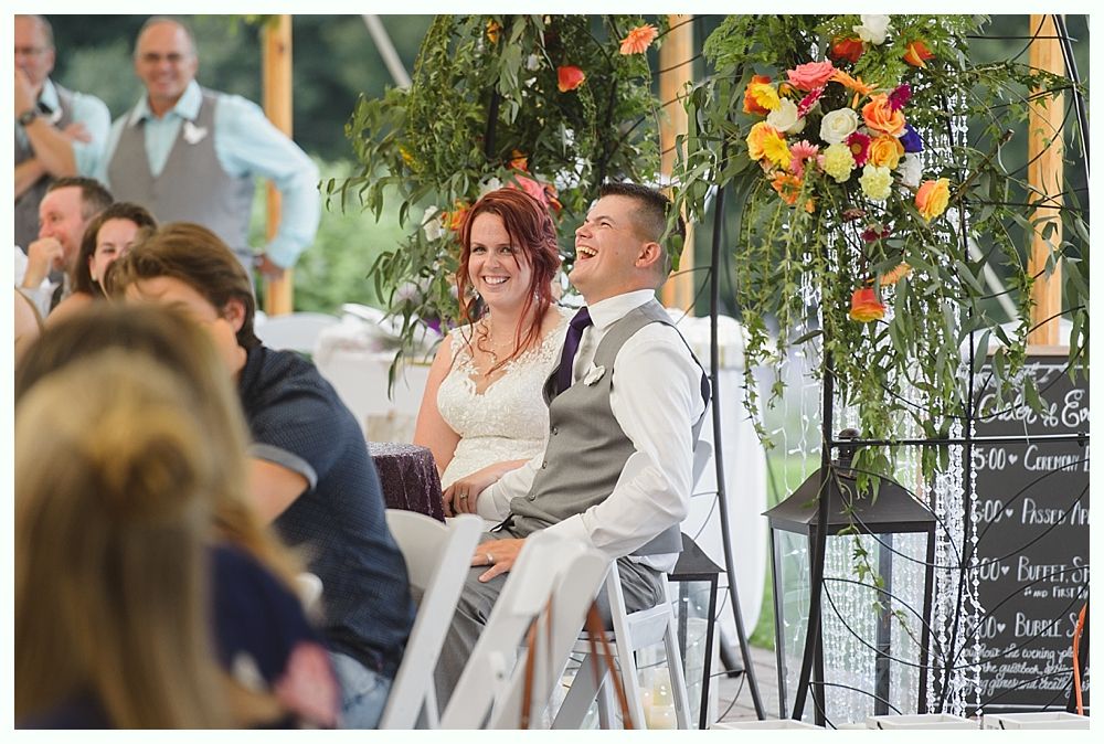 Diamond engagement ring on yellow flower in tall grass.