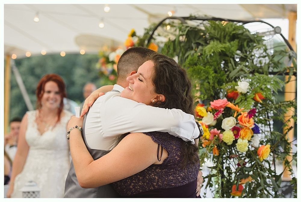 Diamond engagement ring on yellow flower in tall grass.