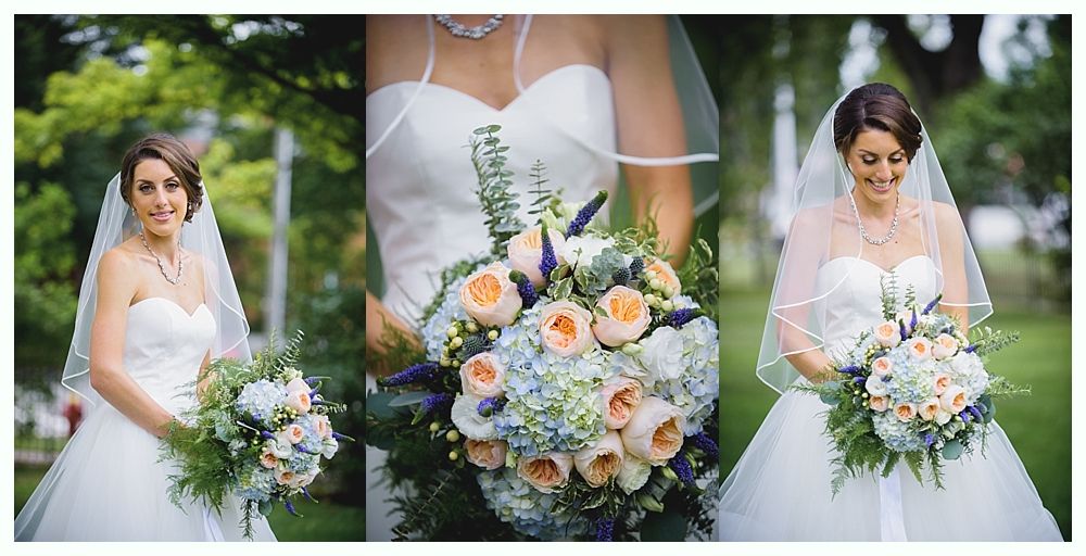 Bride holding bouquet, wearing veil and white gown, standing outside.