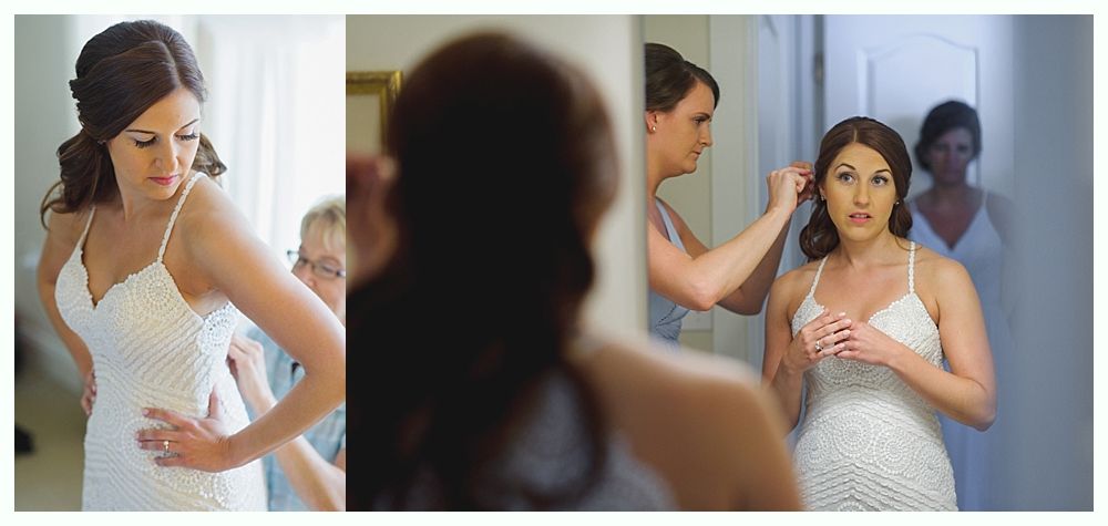 Bride in wedding dress, getting hair and dress adjusted before ceremony.