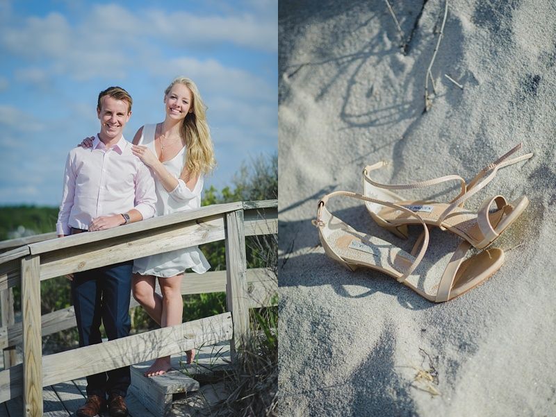 Couple holding hands in a field, woman in red and black outfit looking back, man in a vest.