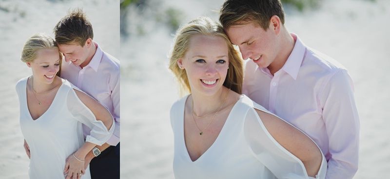 Woman's hand with ring on ornate clothing, with black sleeves, red accents and curly hair.