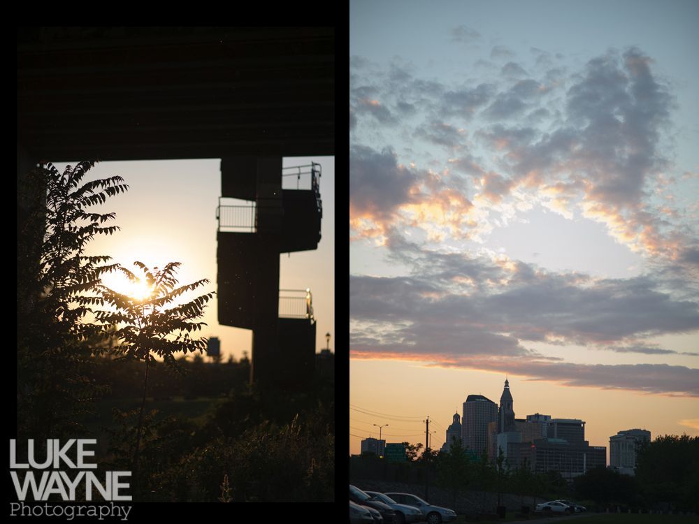Sunset over a city skyline and dark silhouette of a structure, framed by a tunnel entrance.
