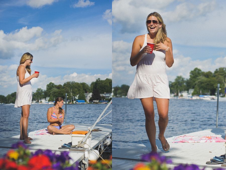 A bride is helped into her wedding dress. A bridesmaid fastens the corset back. The bride's shoes are visible.