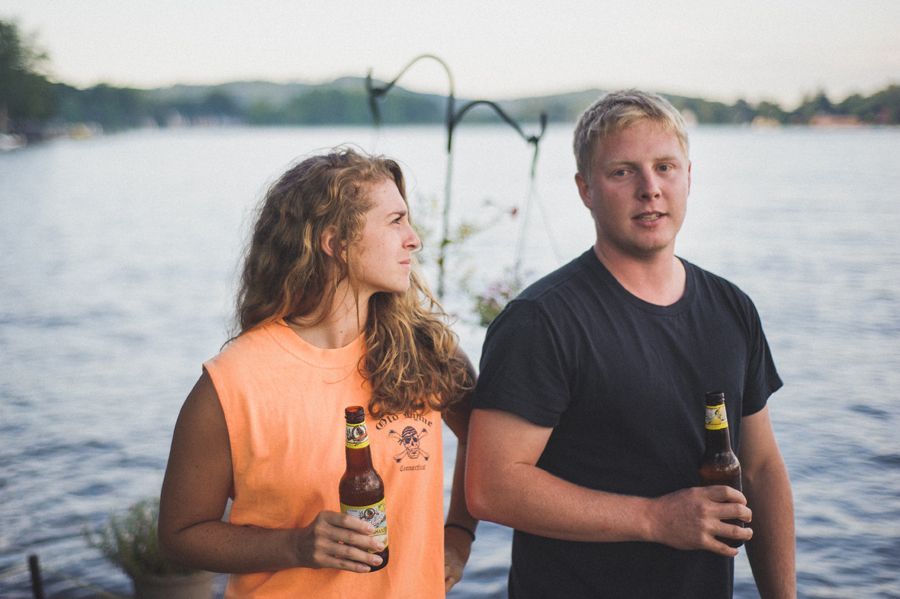 Bride and groom dancing, in a ballroom with draped windows. The groom wears a suit; the bride a strapless dress.
