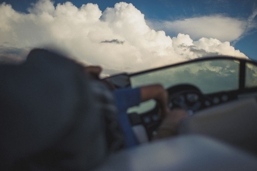 Person taking photo in mirror, indoors; black and white.