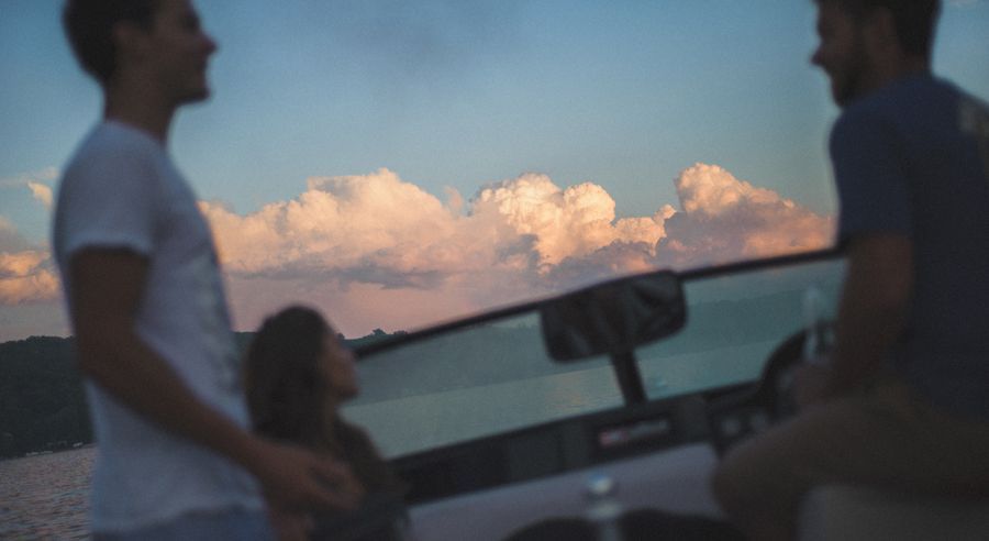Person taking photo in mirror, indoors; black and white.