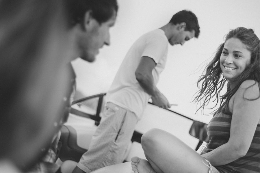 Person taking photo in mirror, indoors; black and white.