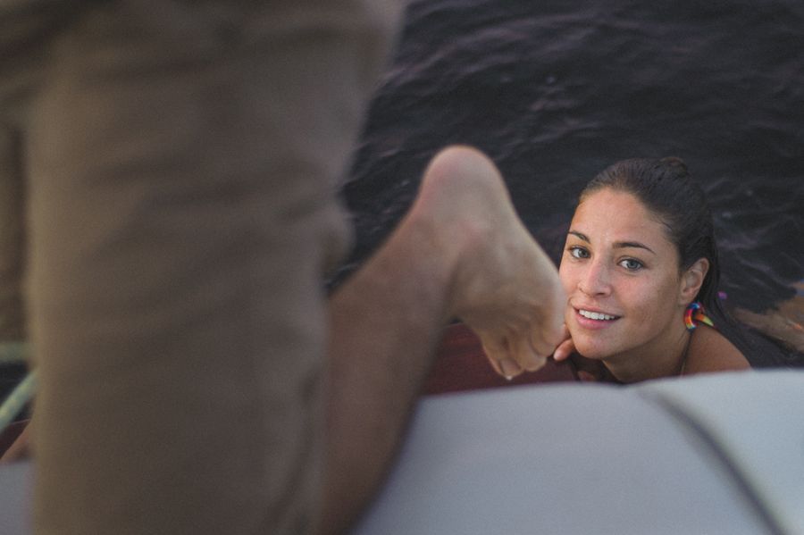 Person taking photo in mirror, indoors; black and white.