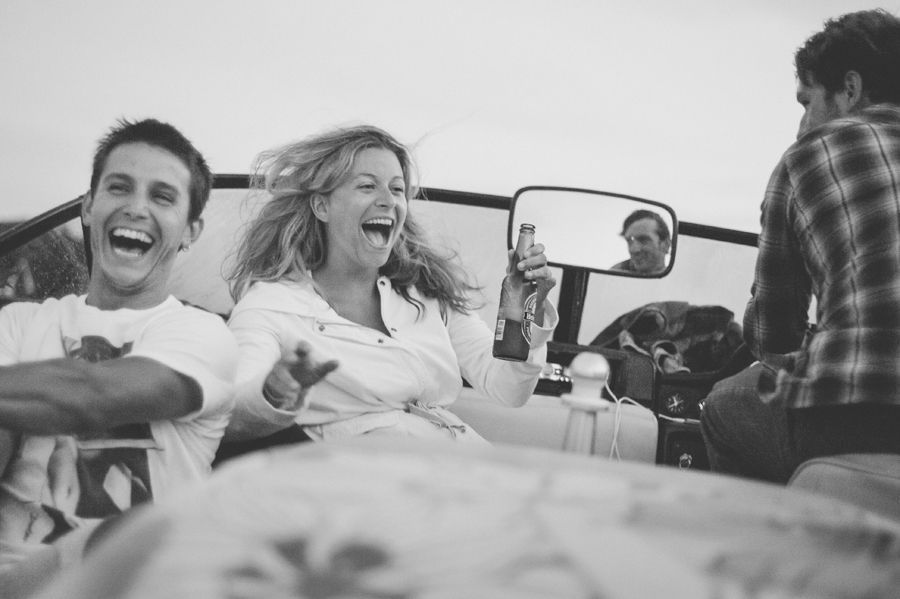 Person taking photo in mirror, indoors; black and white.