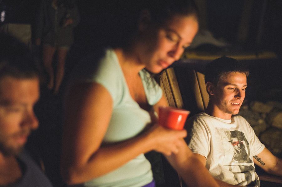Person taking photo in mirror, indoors; black and white.