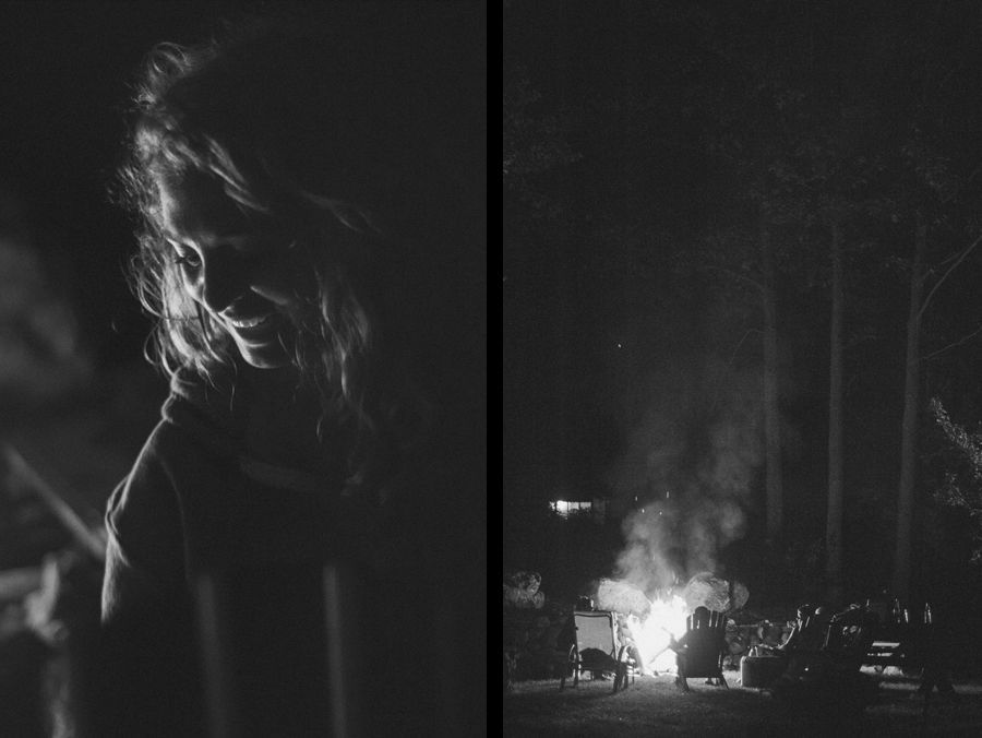 Person taking photo in mirror, indoors; black and white.