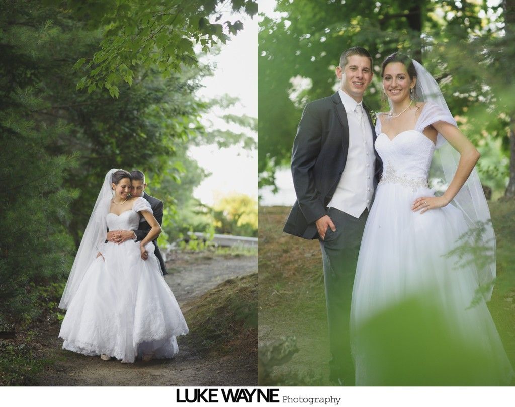 Wedding couple posing outdoors; bride in white gown, groom in dark suit, trees in background.