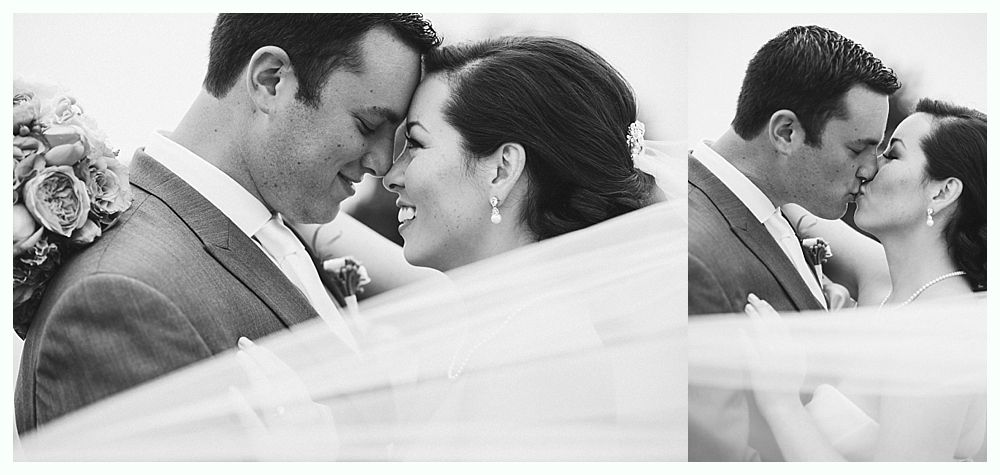 Wedding couple embracing, smiling, and kissing. Black and white photo.