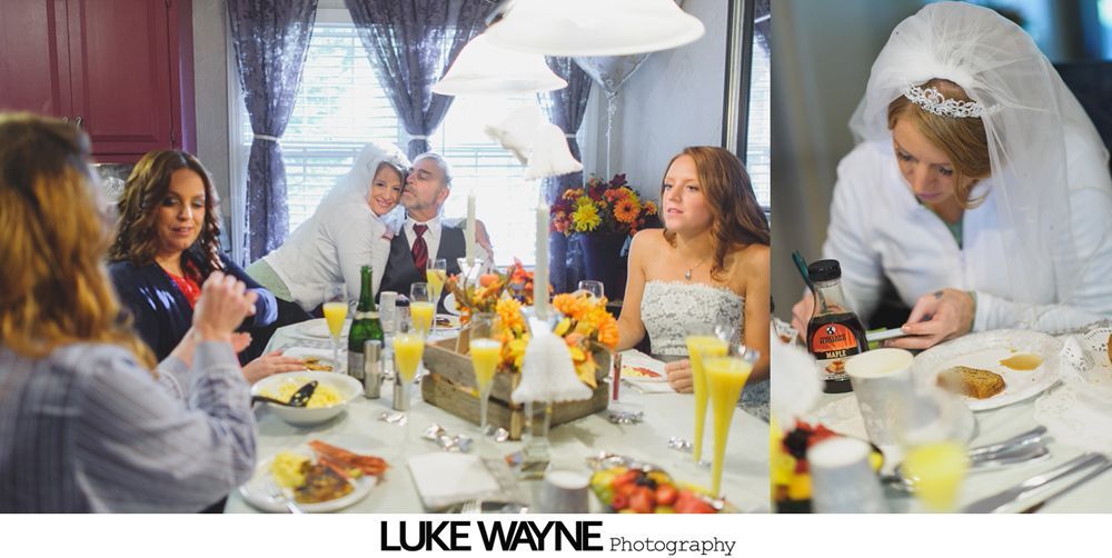 Woman having makeup applied, reflected in mirror. Person in teal robe applies makeup to woman in gray robe.