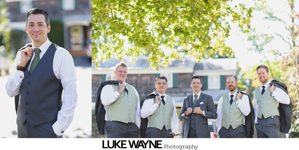 Wedding party poses on a road under blue sky, bride in white gown, bridesmaids in teal.