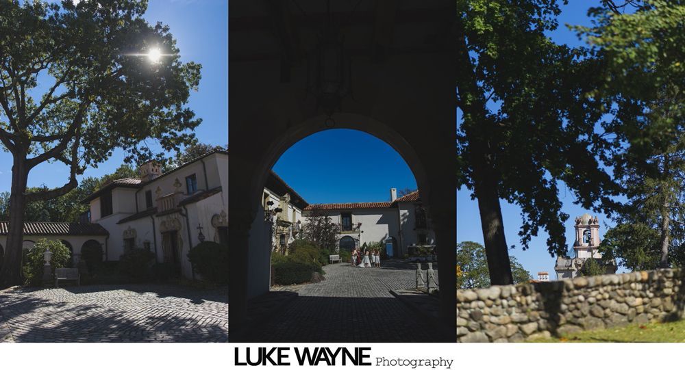 Wedding party poses in a sunny field under a bright blue sky with scattered clouds.