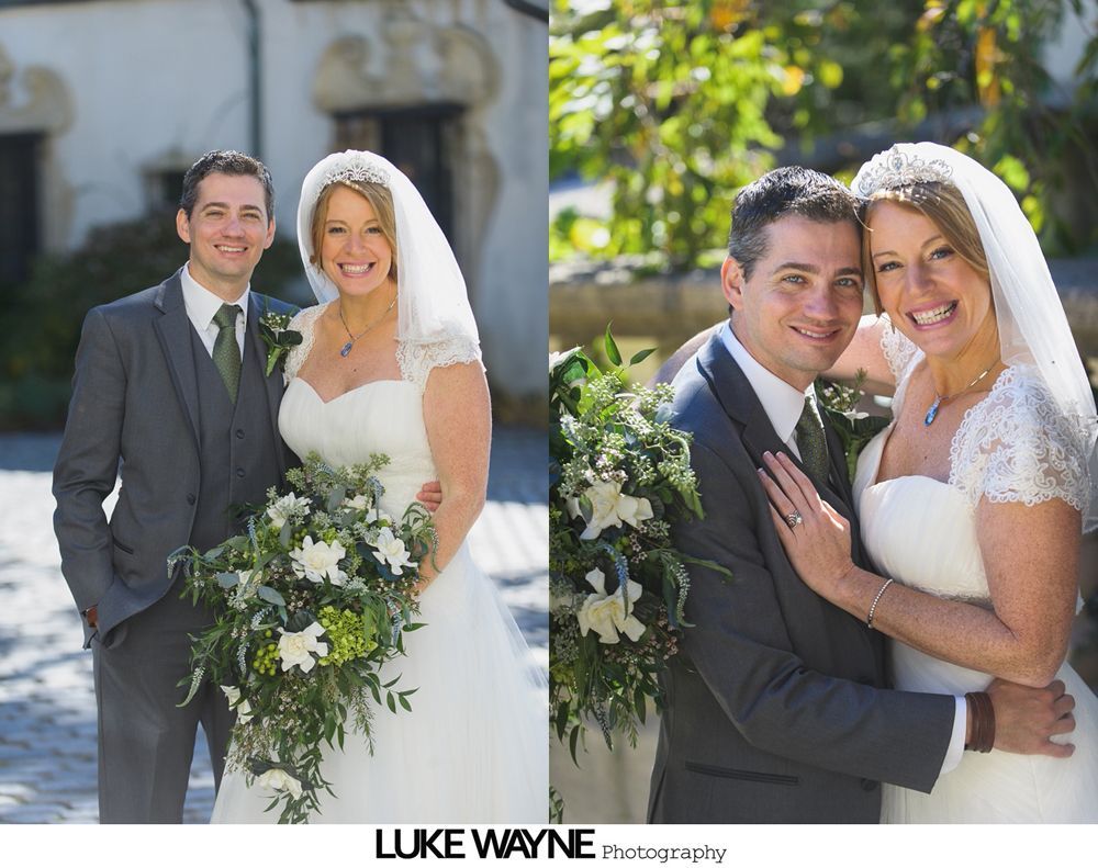 Wedding ceremony: Bride and groom shake hands, smiling, outdoors. Groom wears a black suit, bride a white dress.