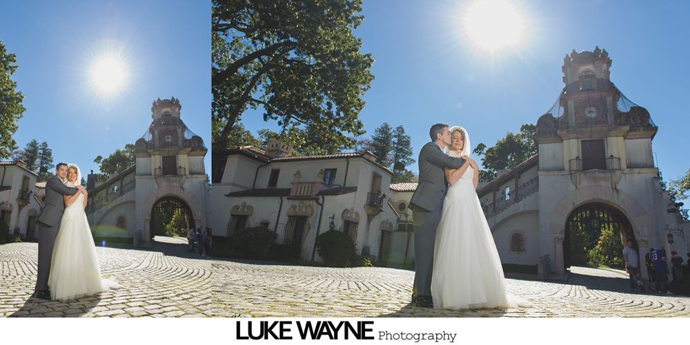 Bride and groom celebrating at an outdoor wedding ceremony, surrounded by the wedding party and guests.
