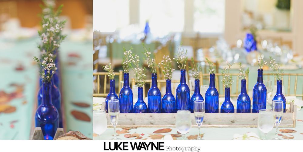 Two men embrace on a dance floor at a wedding reception.