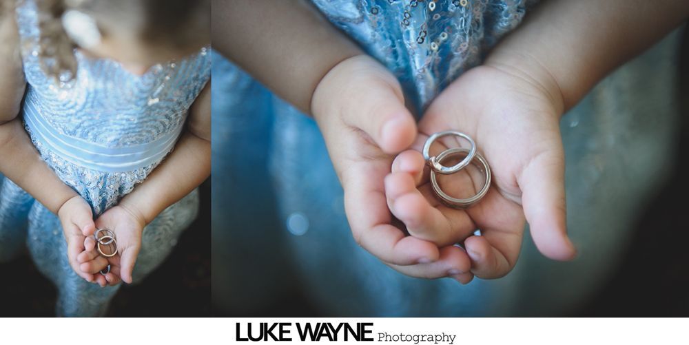 Wedding reception with dancing; bride in a white gown and guests in colorful dresses on a dance floor.