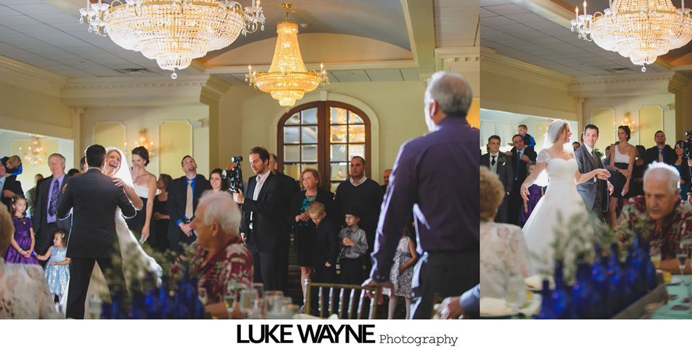 Wedding reception with dancing; bride in a white gown and guests in colorful dresses on a dance floor.