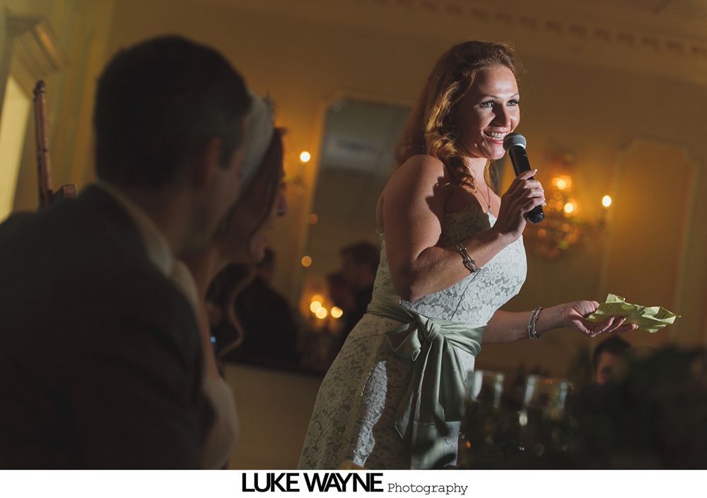 Wedding reception with dancing; bride in a white gown and guests in colorful dresses on a dance floor.