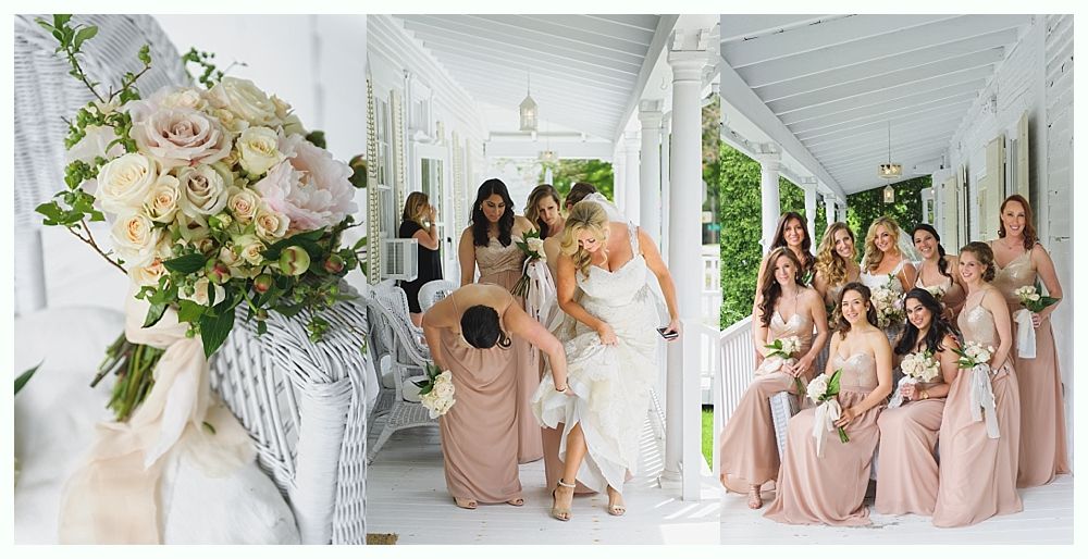 Wedding bouquet, bride, and bridesmaids on a white porch; the bride is helped with her dress.