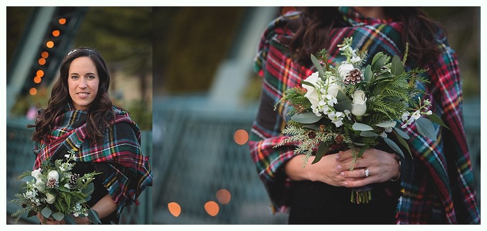 Woman in plaid shawl holding a bouquet of white flowers, standing outdoors.