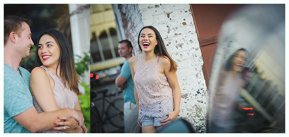 A woman laughs, as two men stand with her. The images are outside.