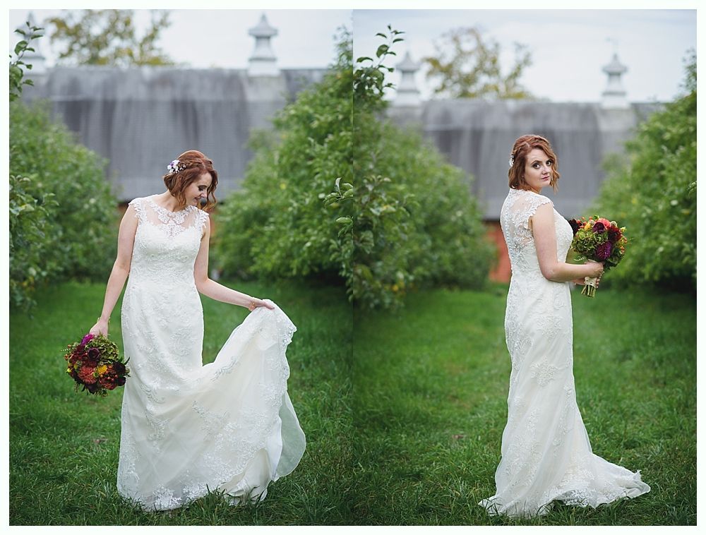Bride in a white lace wedding dress, holding a bouquet. Standing in a garden.