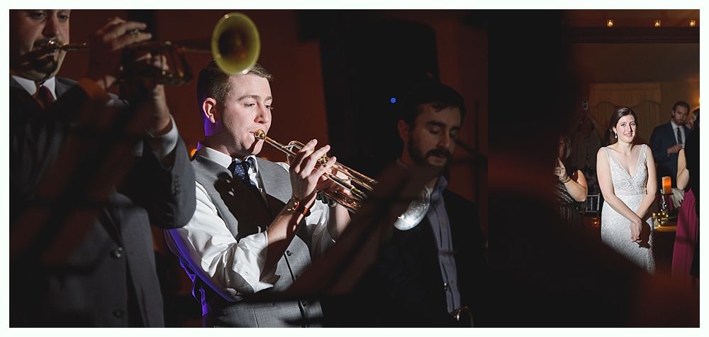 A jazz band plays at a wedding. The bride smiles, looking at the band. Dark interior setting.
