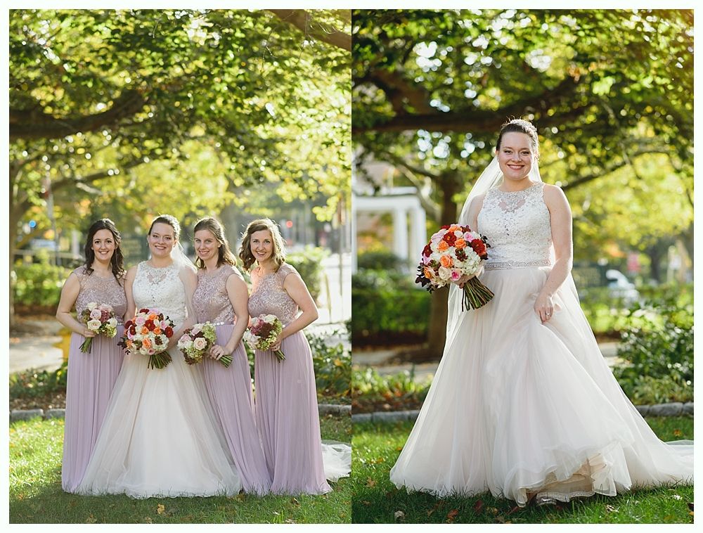 Bride and bridesmaids in wedding attire posing outdoors.