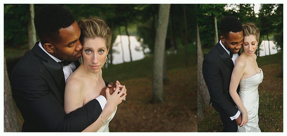 Couple embracing outdoors on wedding day. The woman is looking into the camera with a neutral expression.